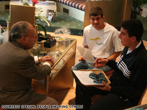 Zachary Peskin, right, and his brother Adam discuss the Special Business Partners Program with a retailer.
