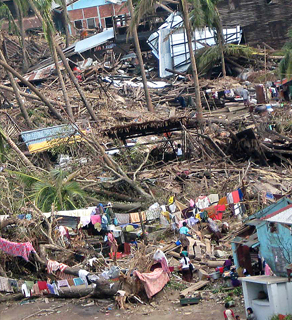 Cyclone affected families waiting for the relief goods outside their destroyed homes.