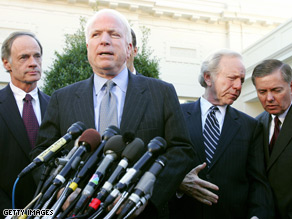 Sens. Carper, Lieberman and Graham stand behind John McCain at a press briefing.