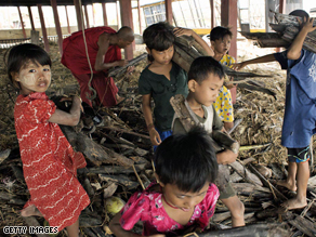 Children help out clearing debris from under the monastery May 10, 2008 in the village of Kyaun Da Min a few hours south of Pyapon, Myanmar.
