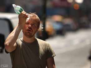 A man tries to cool himself with a bottle of water during the first heat wave of the year in New York City.