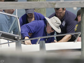 Sen. Kennedy is helped into a boat as he heads out sailing a week after his surgery.