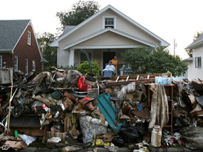 Piles of water destroyed items line the streets in Cedar Rapids, Iowa, Tuesday.