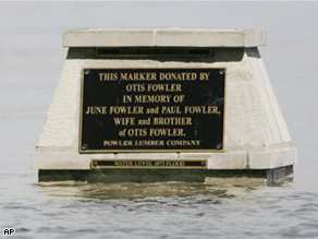Flood waters of the Mississippi River inch closer to the water marker from the 1993 flood, Sunday.