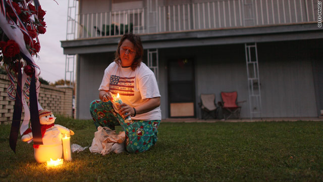 A neighbor of Maj. Nidal Malik Hasan, who did not want to be named, lights candles in the courtyard of their apartment complex.