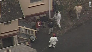 Investigators search the former home of murder suspect Anthony Sowell on Wednesday.