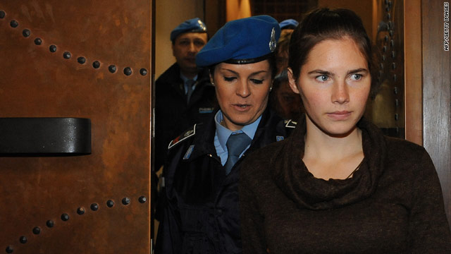 Amanda Knox is escorted into the courtroom Wednesday in Perugia, Italy. She is accused of killing her roommate.