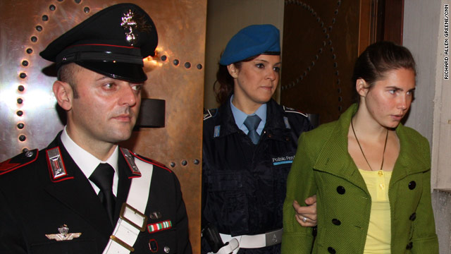 Amanda Knox is led into court in Perugia a day before sentencing.