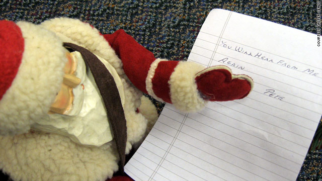 An early gift from "Pete" included a wooden Santa and note reading, "You will hear from me again."
