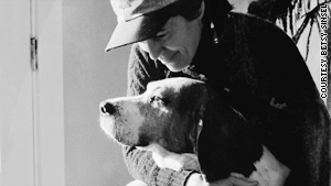 Rita Mae Brown, with one of her many dogs, points out that in the animal world, you pull your own weight.