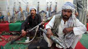 Taliban fighters lay down their weapons as they surrender to the Afghan government in western Afghanistan.