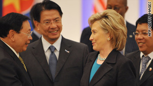 Secretary of State Hillary Clinton, shown with world leaders in Singapore on Sunday, says the Afghan mission is intact.