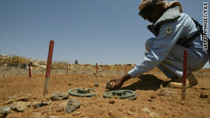 A worker attempts to clear landmines along the border between Jordan and Syria in July 2008.