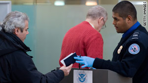 A TSA official checks a passenger's ID at Ronald Reagan Washington National Airport on Tuesday.