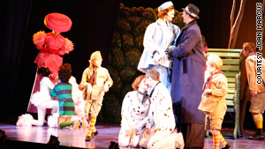 Actors play some of the dogs, while cast members on stilts portray the "humans."
