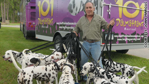 Trainer Joel Slaven shows off some of the Dalmatians outside the musical show's traveling bus and trailer.