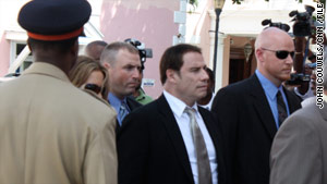 John Travolta, center, and his wife, Kelly Preston, enter the courthouse in the Bahamas last month.