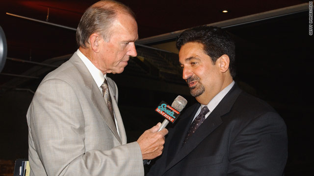 George Michael (left, interviewing Washington Capitals co-owner Ted Leonsis in 2002) retired from broadcasting in 2007.