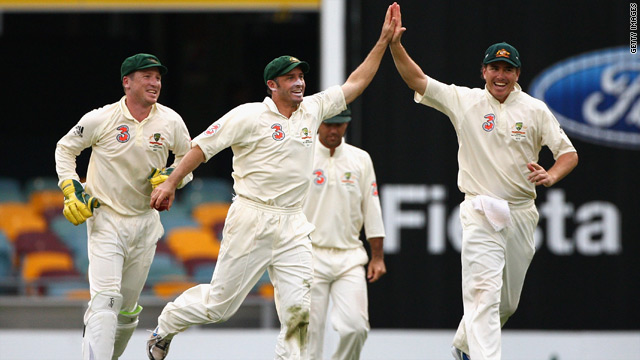 Michael Hussey, left center, and Marcus North celebrate as Australia take another wicket against the West Indies.