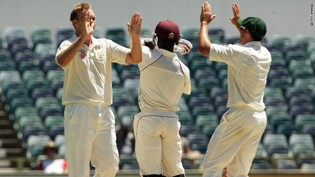 Bollinger celebrates taking the final wicket as Roach stands his ground at the WACA.