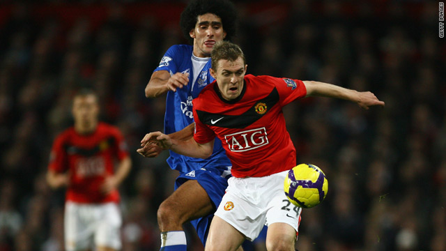 Manchester United midfielder Darren Fletcher shields the ball from Everton's Marouane Fellaini.