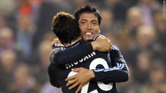 Real hero Ezequiel Garay is congratulated by his compatriot Gonzalo Higuain, who also scored twice.