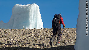 A researcher passes a shrinking fragment of the Northern Ice Field on Kilimanjaro's plateau.