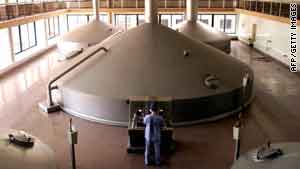 A worker operates the giant fermentation units at the Qingdao Brewery plant in Qingdao.