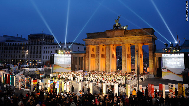 Tourists gather along the former route of the Berlin Wall in front of the Brandenburg Gate in Berlin, Germany.