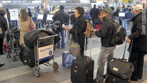 Passengers wait in line Thursday morning at New York's LaGuardia Airport, one of the affected airports.