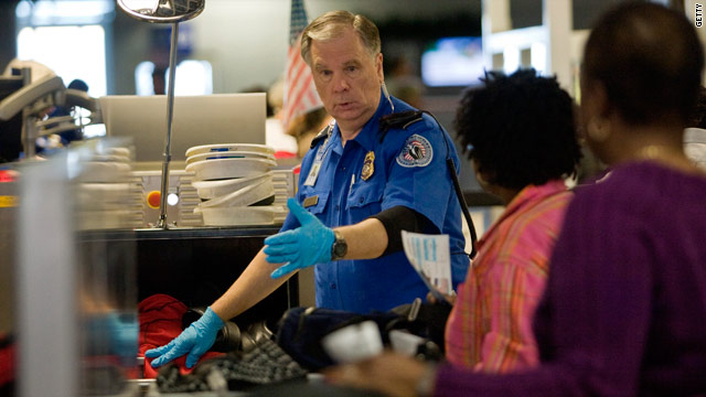 A TSA officer screens airline passengers at Dallas/Fort Worth International Airport December 27, 2009 in Dallas, Texas.