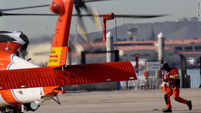 A Coast Guard search team member approaches a helicopter Friday in San Diego, California.
