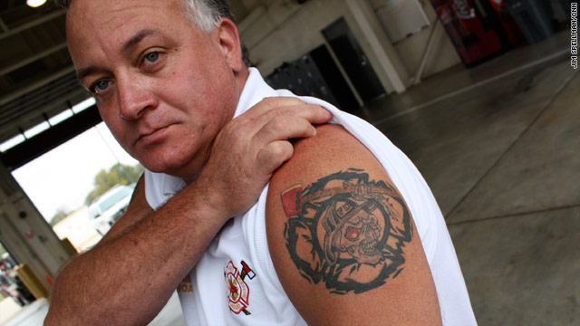 Fire chief Billy Rhoads displays his tattoo of brotherhood. "I just could not fathom what we were going to encounter."
