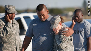 Sgt. Fanuaee Vea, left, embraces Pvt. Savannah Green after shootings outside Fort Hood in Texas.