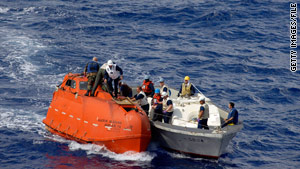 U.S. Navy personnel help tow a lifeboat in April after snipers killed three pirates and rescued a cargo ship's captain.