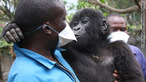 Ndeze cuddles with chief caregiver Andre Bauma.