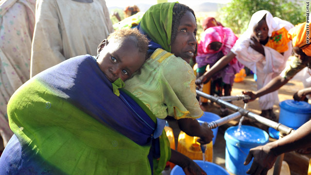 Refugees from Darfur fill buckets with water at a camp in Chad.