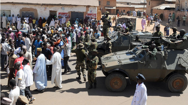 Soldiers stand guard after December 2008 post-election riots in central Nigeria leave hundreds dead.