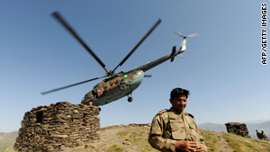 A Pakistani army officer walks down from a hill top after landing in a helicopter in Mingora on June 3, 2009.