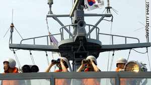 South Korean Navy sailors signal a North Korean warship on the western maritime border on 14 June 2004.