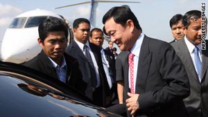 Former Thai prime minister Thaksin Shinawatra arrives at a military air base in Phnom Penh.