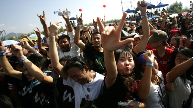 Audience members cheer during a performance of the 2007 Snow Mountain Music Festival in Lijiang, Yunnan Province, China.