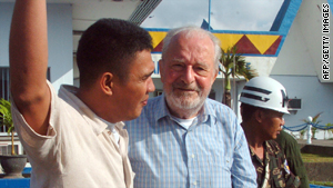 Released Irish priest Michael Sinnott, center, is escorted at a military airbase in Zamboanga City on Thursday.