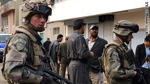 Troops wth NATO's International Security Assistance Force survey the scene after an attack in Afghanistan.