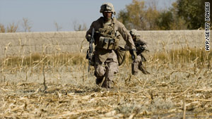 A U.S. Marine runs for cover after his unit comes under fire in Afghanistan's Helmand Province on Wednesday.