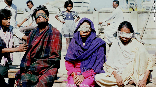 Victims blinded by methyl isocyanate gas are attended to outside the Union Carbide plant after the disaster of December 3, 1984.