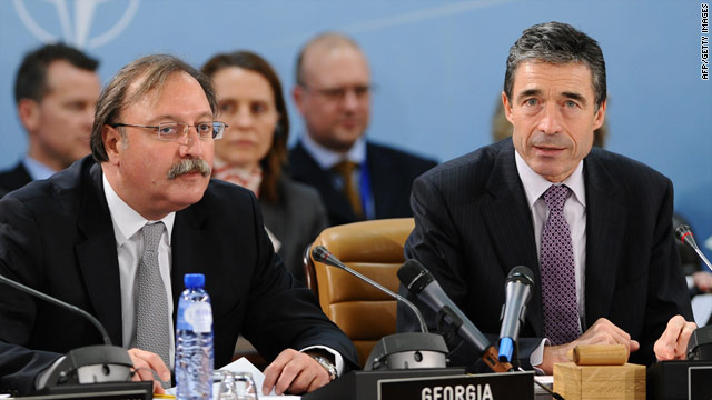 NATO Secretary General Anders Fogh Rasmussen (R) attends a NATO meeting in Brussels on Thursday, December 3
