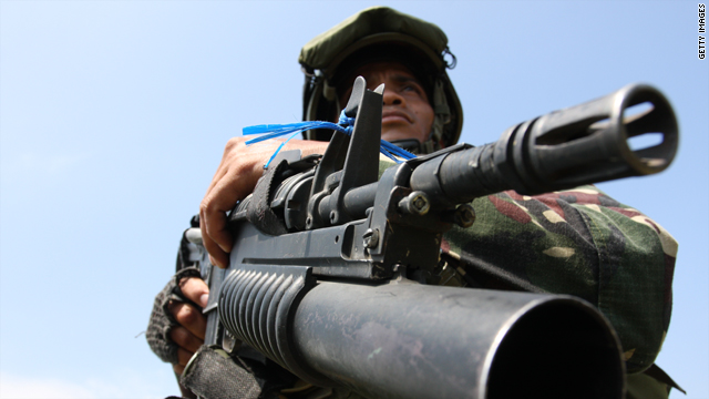 A Filipino soldier secures the site where weapons and ammunition were dug up on December 6 in Maguindanao.