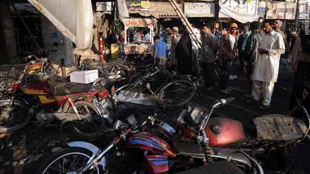 Residents in Lahore, Pakistan, gather on Tuesday in the aftermath of a bomb attack on a market.