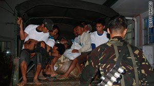 Filipino civilians arrive at a hospital after they were released by a group of tribal gunmen.